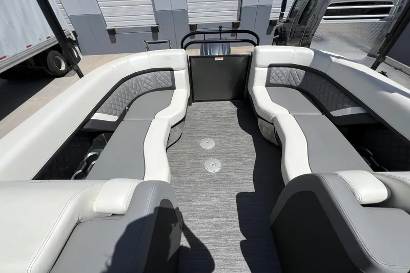 Slide: The Image of Interior of 2022 Godfrey AquaPatio 255 SBW pontoon boat with gray and white seating. - 13