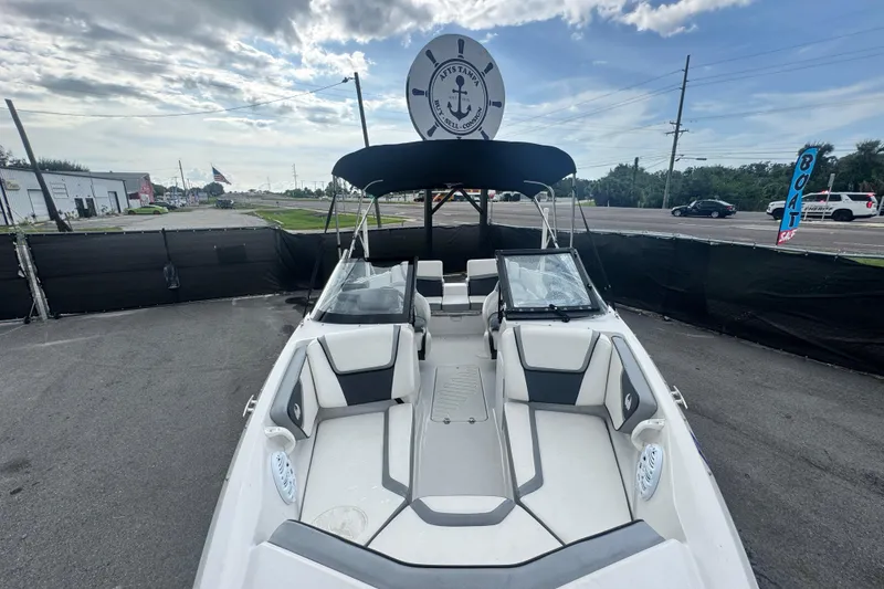 Slide: The Image of 2018 Scarab 195 G boat with seating, parked outdoors under cloudy sky. - 16
