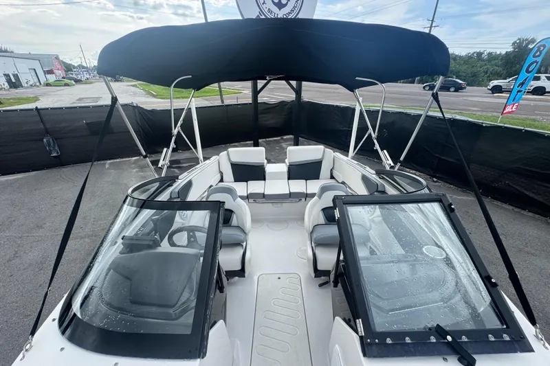 Slide: The Image of 2018 Scarab 195 G boat with black canopy and spacious seating. - 17