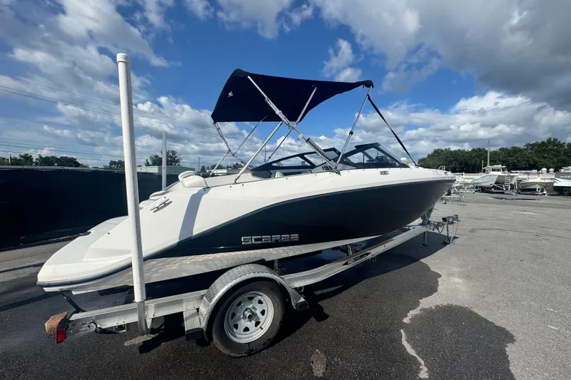Slide: The Image of 2018 Scarab 195 G boat on trailer under blue sky with clouds. - 2