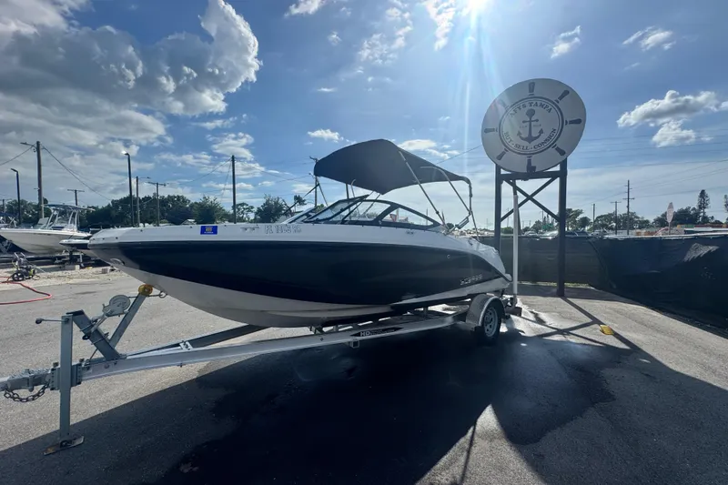 Slide: The Image of 2018 Scarab 195 G boat on trailer under sunny sky at marina. - 5
