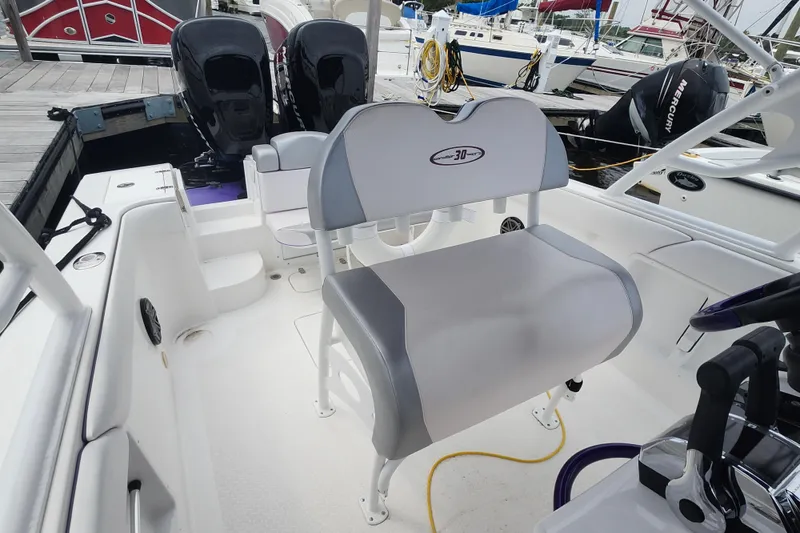 Slide: The Image of 2014 Concept 30 Cuddy boat interior with dual engines and seating at dock. - 17