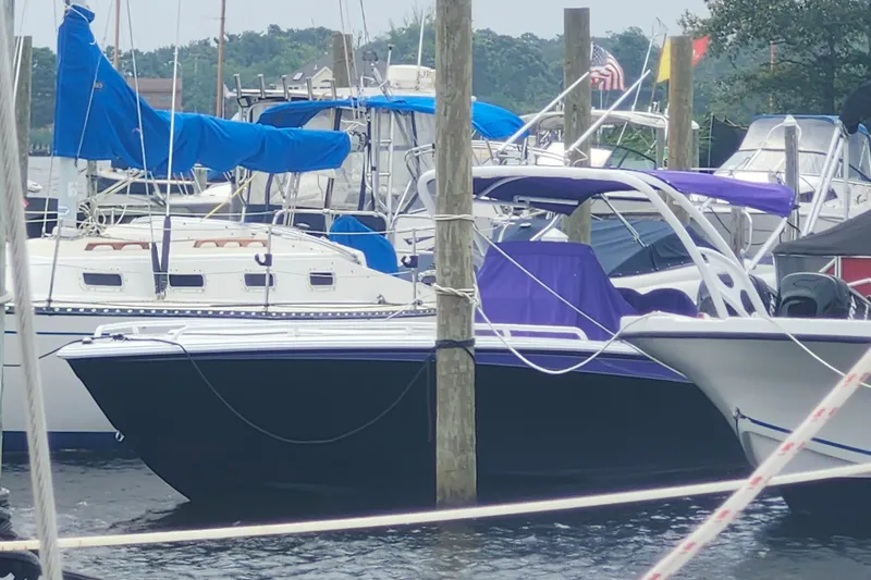 Slide: The Image of 2014 Concept 30 Cuddy boat docked among other vessels at a marina. - 2