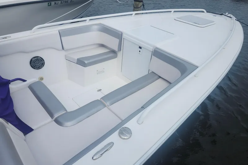 Slide: The Image of 2014 Concept 30 Cuddy boat interior with white and gray seating, docked on water. - 20