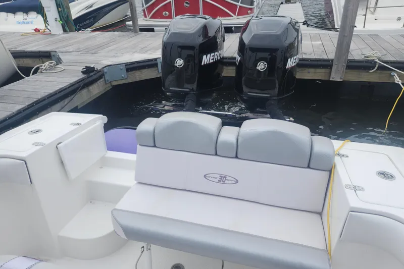 Slide: The Image of 2014 Concept 30 Cuddy boat with twin Mercury engines docked at marina. - 22