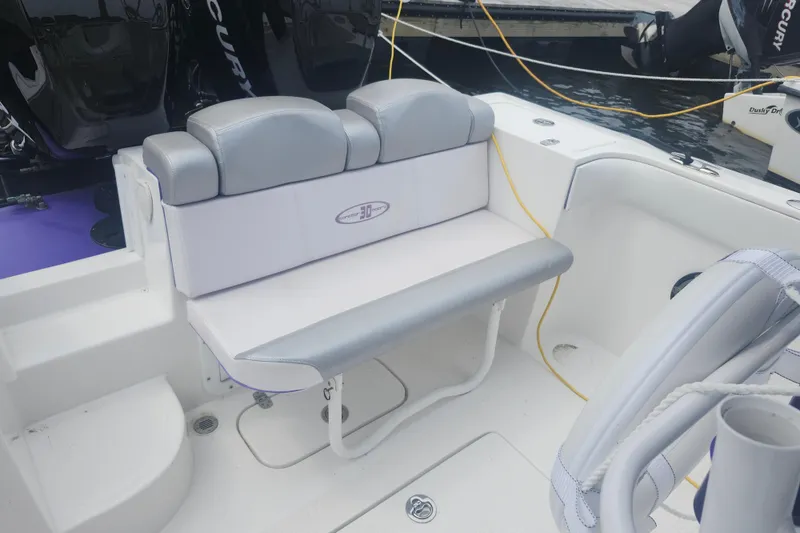 Slide: The Image of 2014 Concept 30 Cuddy boat seating area with gray and white upholstery. - 23