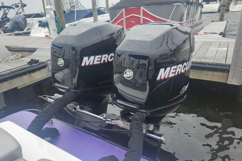 Slide: The Image of Twin Mercury outboard engines on a 2014 Concept 30 Cuddy boat at a marina. - 29