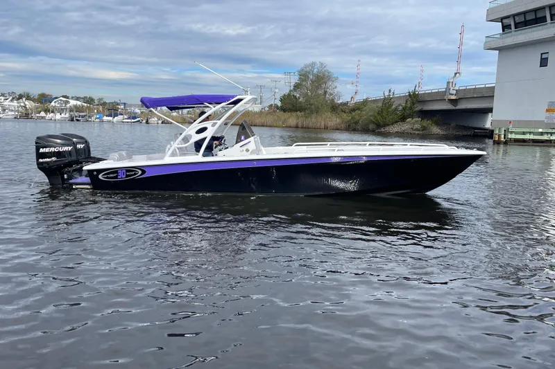Slide: The Image of 2014 Concept 30 Cuddy boat with Mercury engine on a calm waterway. - 37
