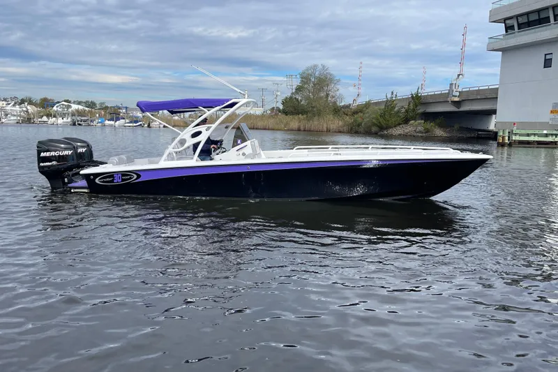 Slide: The Image of 2014 Concept 30 Cuddy boat on water, featuring sleek design and Mercury outboard engines. - 38