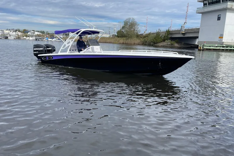 Slide: The Image of 2014 Concept 30 Cuddy boat on water near a bridge, featuring Mercury engines. - 39