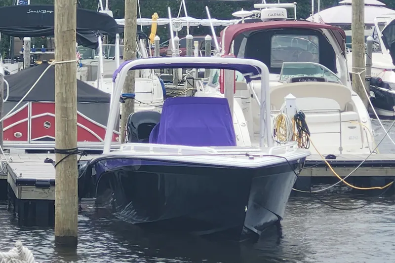 Slide: The Image of 2014 Concept 30 Cuddy boat docked at marina, surrounded by other vessels. - 4
