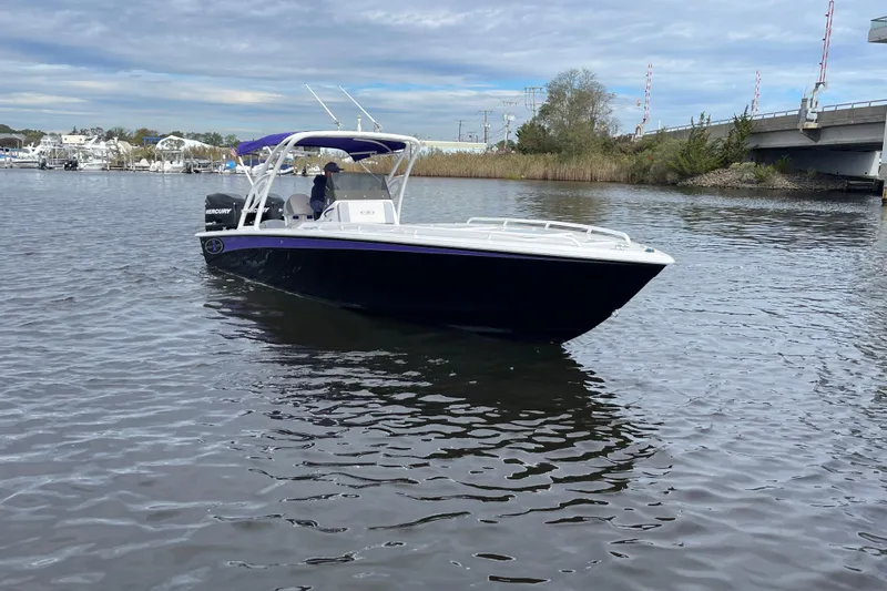 Slide: The Image of 2014 Concept 30 Cuddy boat on calm water near a bridge and marina. - 41