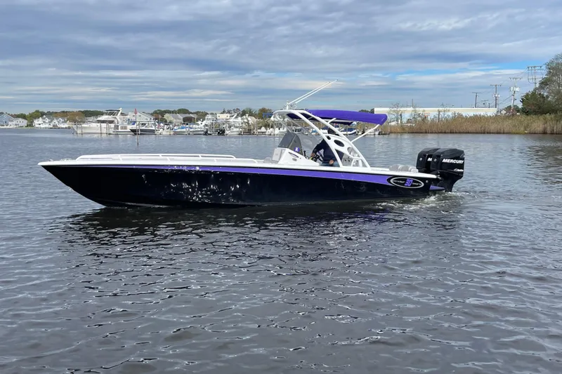 Slide: The Image of 2014 Concept 30 Cuddy boat on calm water with dual Mercury engines. - 47