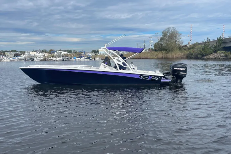 Slide: The Image of 2014 Concept 30 Cuddy boat with Mercury engine on calm water. - 49