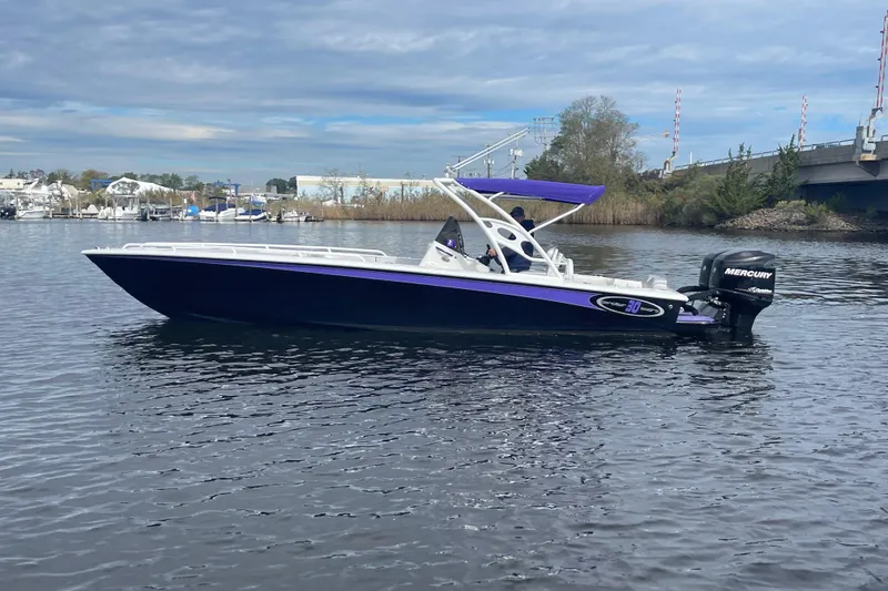 Slide: The Image of 2014 Concept 30 Cuddy boat on calm water with Mercury outboard engine. - 50