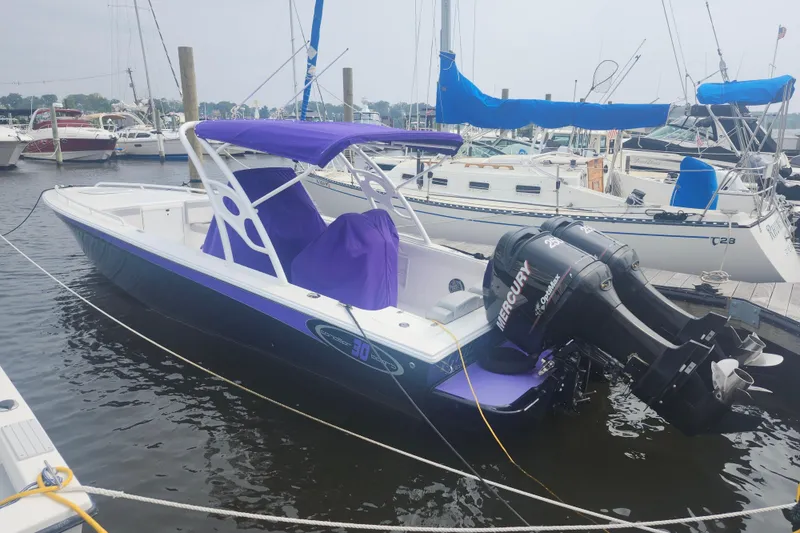 Slide: The Image of 2014 Concept 30 Cuddy boat with purple canopy and twin Mercury outboard engines docked in marina. - 8