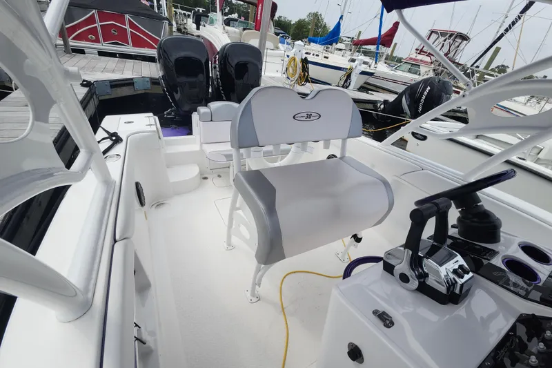 Slide: The Image of 2014 Concept 30 Cuddy boat interior with dual engines and modern controls at a marina. - 9