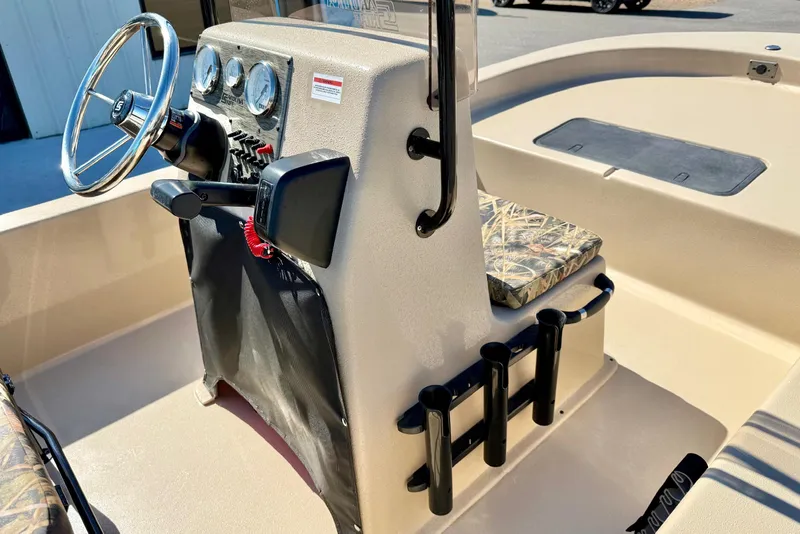 Slide: The Image of 2026 Carolina Skiff E18 JVX CC boat console with steering wheel and rod holders. - 19