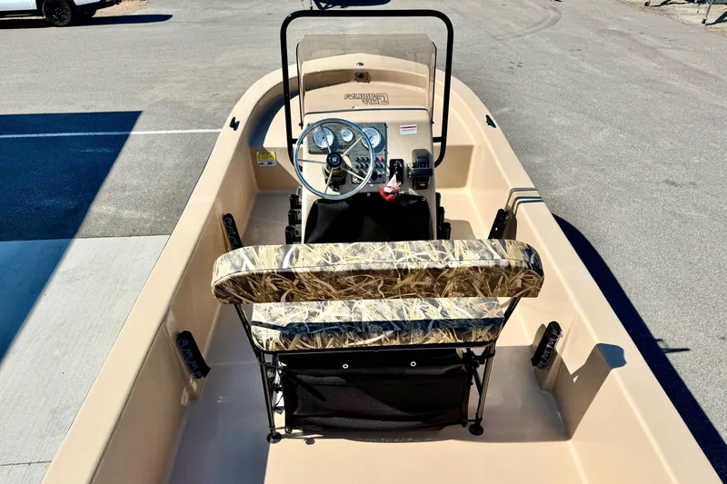 Slide: The Image of 2026 Carolina Skiff E18 JVX CC boat interior with camo seating and steering console. - 21