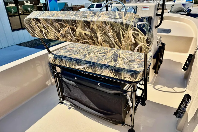 Slide: The Image of 2026 Carolina Skiff E18 JVX CC boat interior with camo seating and storage. - 22