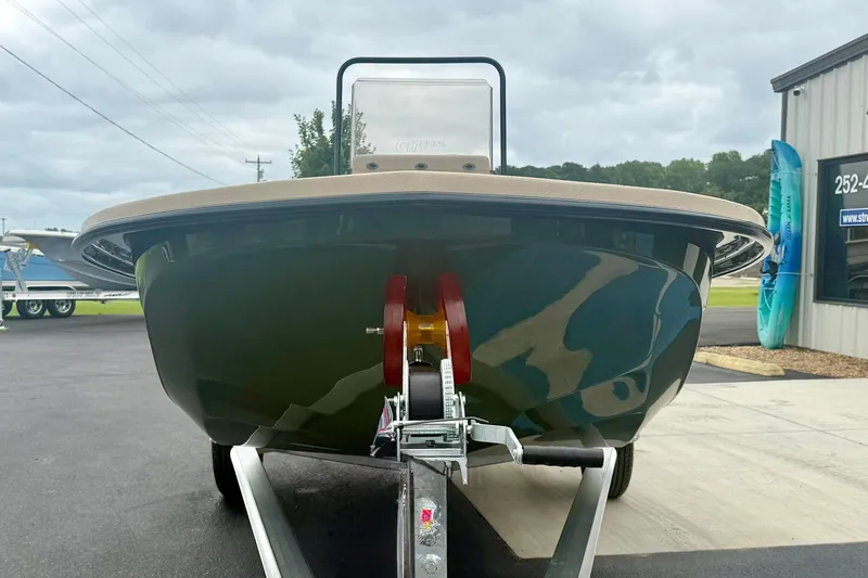 Slide: The Image of 2026 Carolina Skiff E18 JVX CC boat on trailer, front view, overcast sky. - 8
