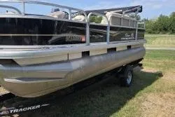 Slide: The Image of 2021 Sun Tracker Bass Buggy 18 DLX pontoon boat on a grassy area. - 3