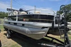 Slide: The Image of 2021 Sun Tracker Bass Buggy 18 DLX pontoon boat on trailer, side view. - 4