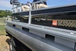 Slide: The Image of 2021 Sun Tracker Bass Buggy 18 DLX pontoon boat on trailer, side view. - 5