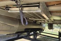 Slide: The Image of 2021 Sun Tracker Bass Buggy 18 DLX pontoon boat underside on trailer. - 6