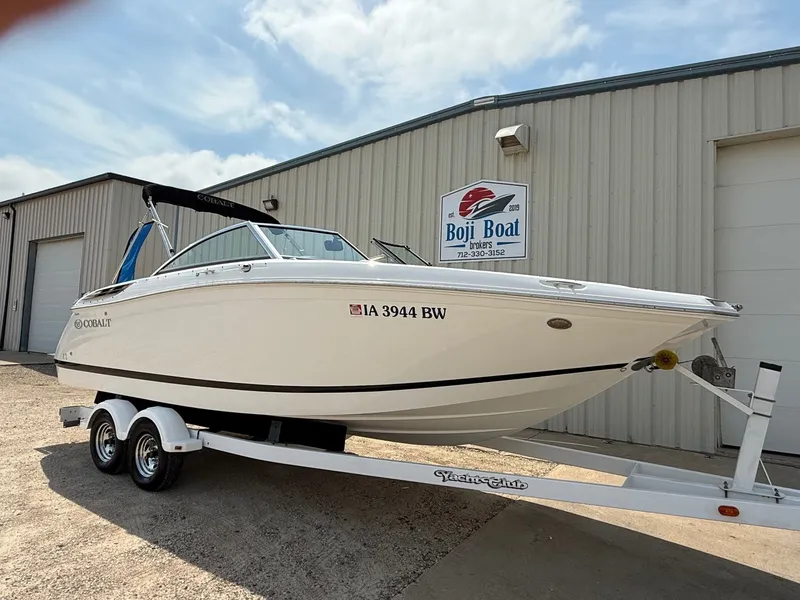 Slide: The Image of 2014 Cobalt 24SD boat on trailer outside Boji Boat Brokers building. - 1