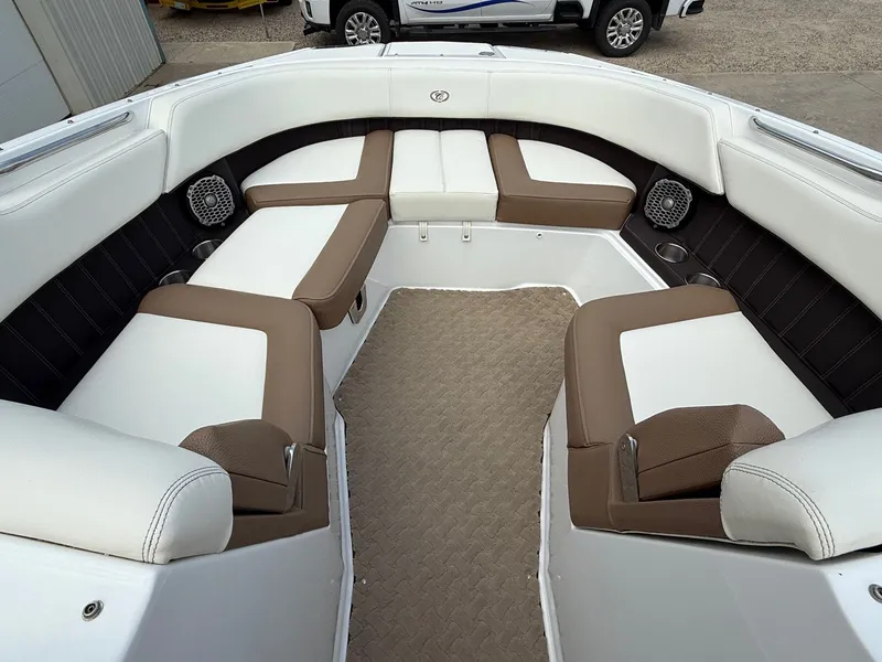 Slide: The Image of Interior of a 2014 Cobalt 24SD boat with white and brown seating. - 12