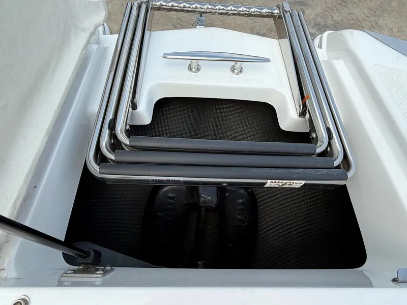 Slide: The Image of 2014 Cobalt 24SD boat ladder and storage compartment detail. - 13