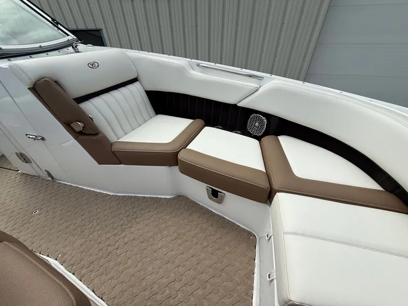 Slide: The Image of 2014 Cobalt 24SD boat interior with white and brown seating, textured flooring. - 15