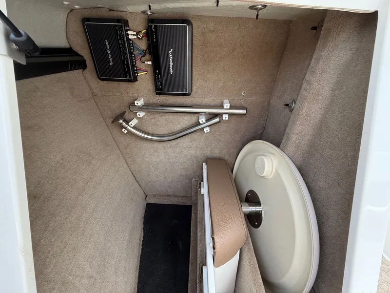 Slide: The Image of 2014 Cobalt 24SD boat storage compartment with audio equipment and accessories. - 16