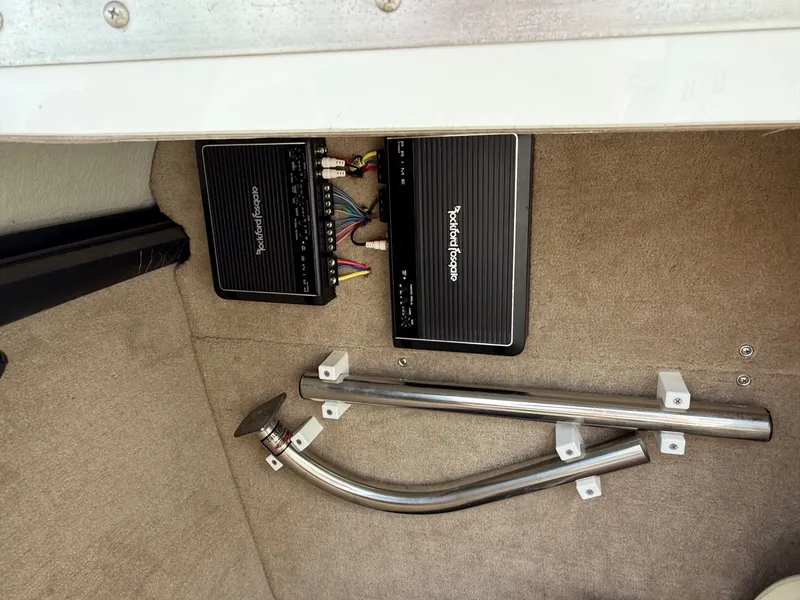 Slide: The Image of Audio amplifiers and metal pipes in a 2014 Cobalt 24SD boat interior. - 17