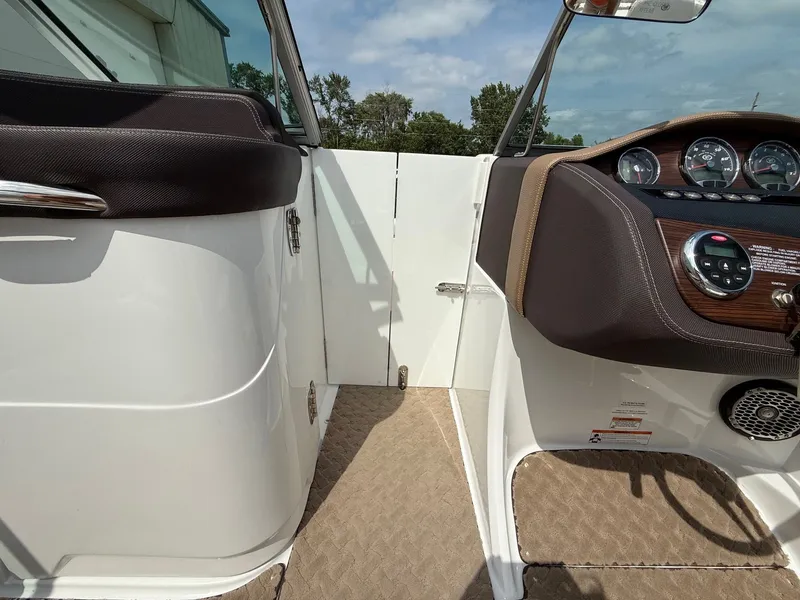 Slide: The Image of Interior view of a 2014 Cobalt 24SD boat dashboard and seating area. - 18