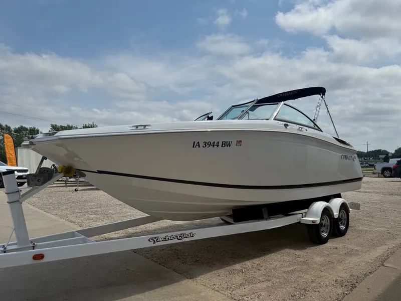 Slide: The Image of 2014 Cobalt 24SD boat on trailer under cloudy sky. - 2