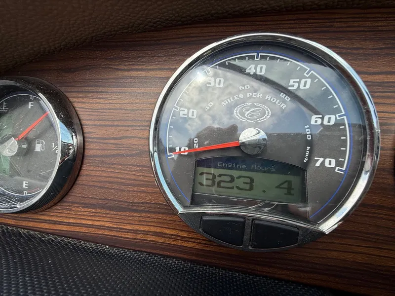 Slide: The Image of Dashboard of 2014 Cobalt 24SD showing speedometer and engine hours at 323.4. - 21
