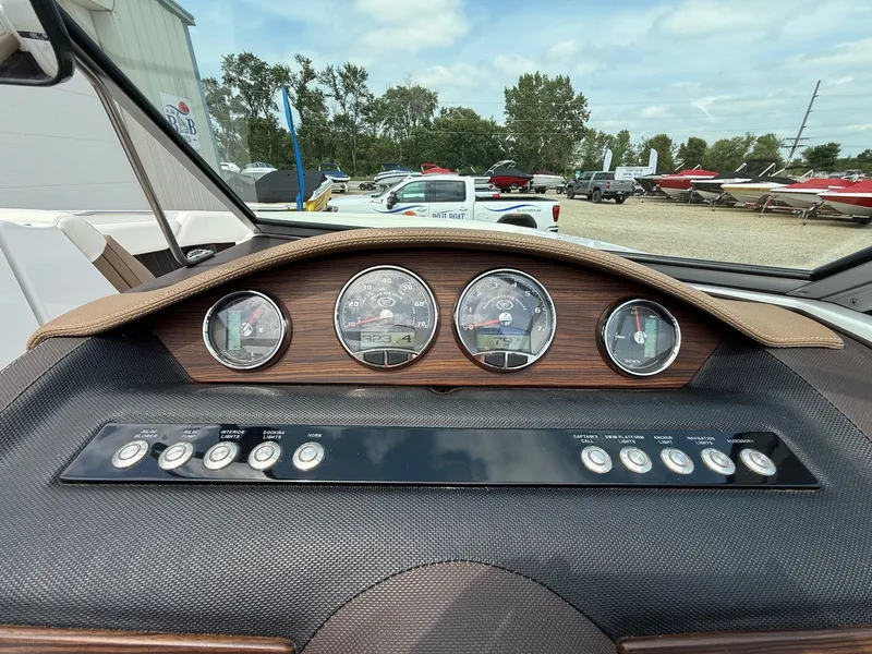 Slide: The Image of Dashboard of a 2014 Cobalt 24SD boat with gauges and control buttons. - 22