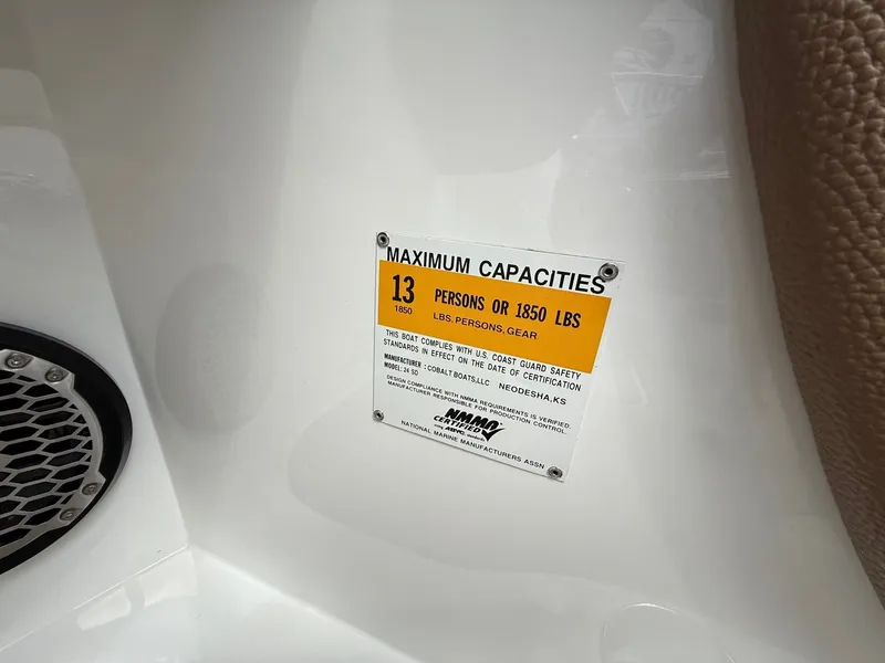 Slide: The Image of Capacity label on 2014 Cobalt 24SD boat: 13 persons or 1850 lbs. - 23