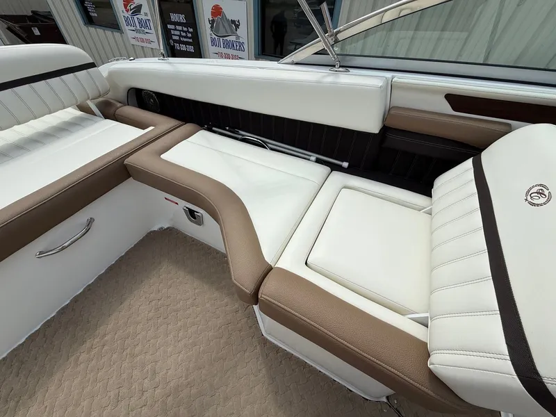 Slide: The Image of 2014 Cobalt 24SD boat interior with white and brown seating, luxurious design. - 26