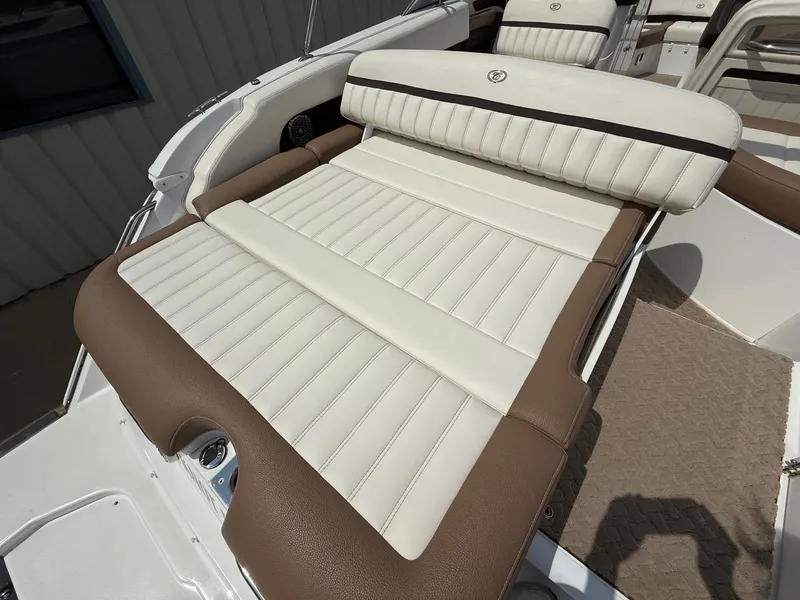 Slide: The Image of 2014 Cobalt 24SD boat with white and brown cushioned seating. - 29