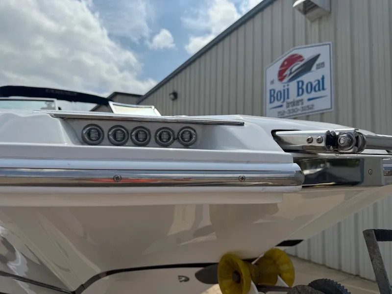 Slide: The Image of 2014 Cobalt 24SD boat detail at Boji Boat Brokers, under a partly cloudy sky. - 3