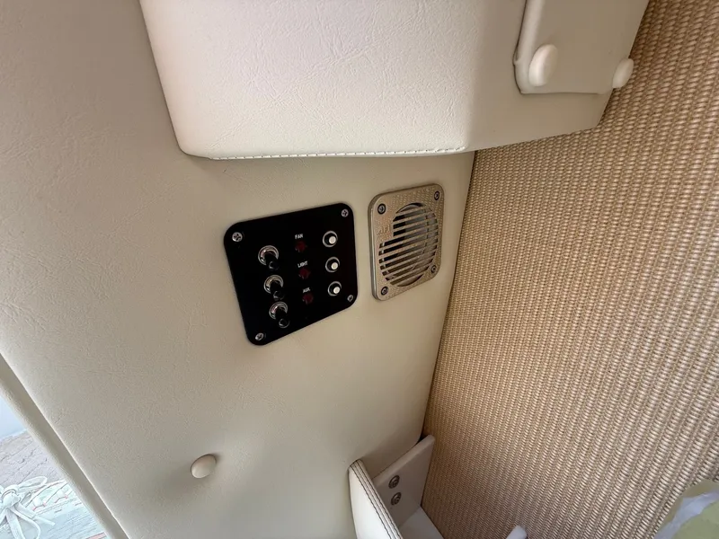 Slide: The Image of Control panel and speaker on 2014 Cobalt 24SD boat interior. - 32