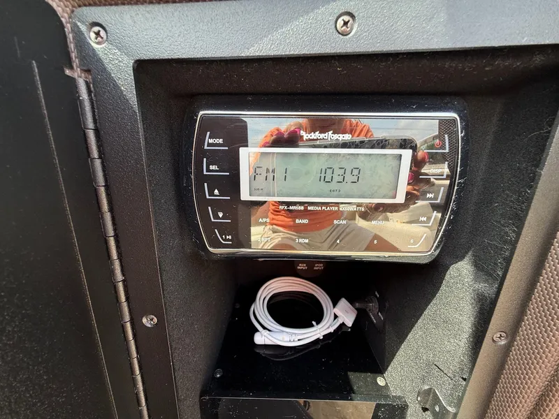 Slide: The Image of Boat stereo system in a 2014 Cobalt 24SD, displaying FM 103.9. - 33