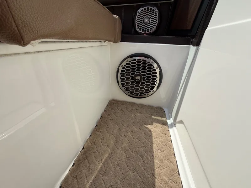Slide: The Image of 2014 Cobalt 24SD boat interior with speaker and carpeted floor. - 35