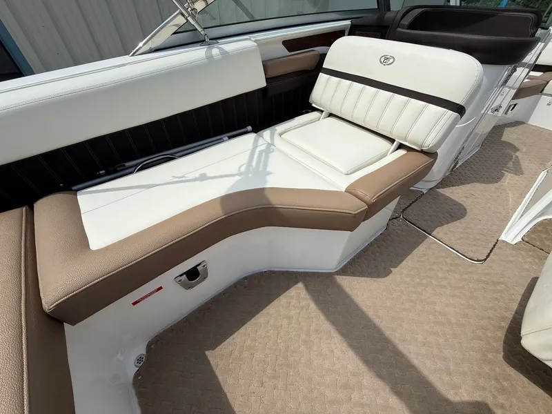 Slide: The Image of 2014 Cobalt 24SD boat interior with white and brown seating. - 36