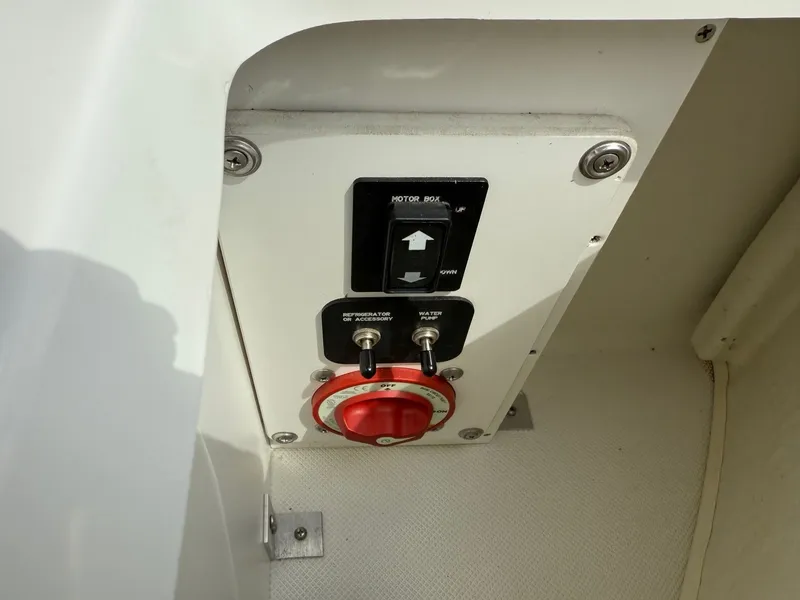 Slide: The Image of Control panel on a 2014 Cobalt 24SD boat with switches and a red dial. - 41