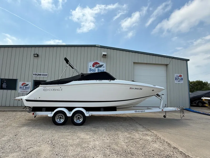 Slide: The Image of 2014 Cobalt 24SD boat on trailer outside Boji Boat dealership. - 46
