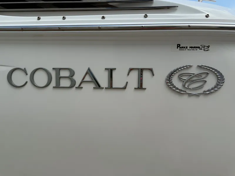 Slide: The Image of 2014 Cobalt 24SD boat logo on white surface. - 5